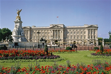 Buckingham Palace in the background with a large statue and gardens to the front